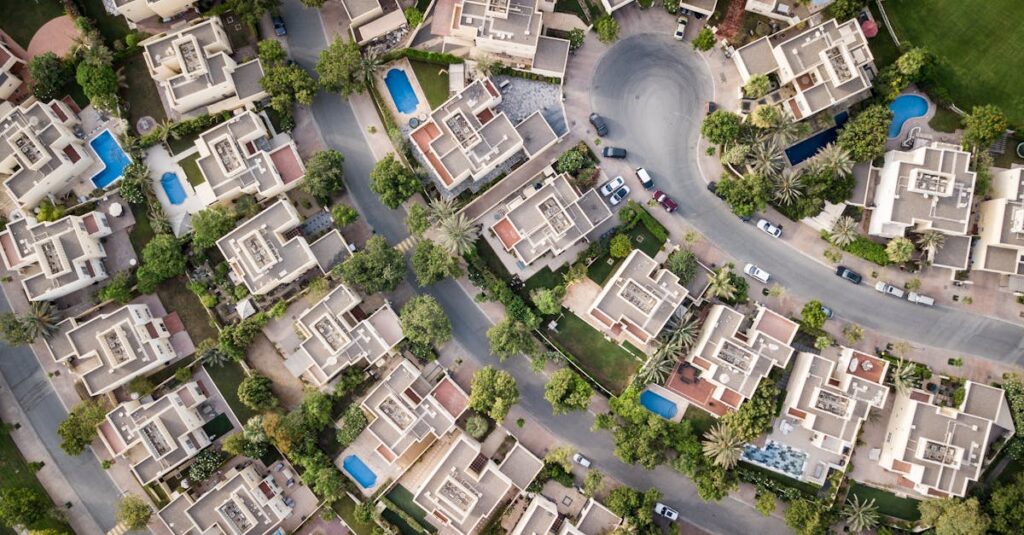 Explore a stunning aerial view of a residential area in Gurgaon with lush greenery and swimming pools.
