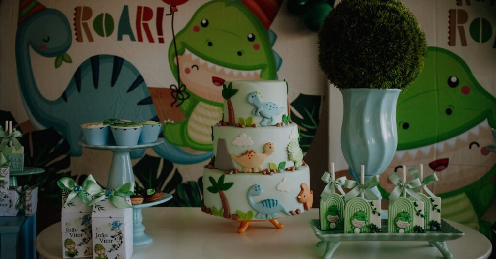 Colorful dinosaur-themed birthday cake and table setup with decorations for a children's party.