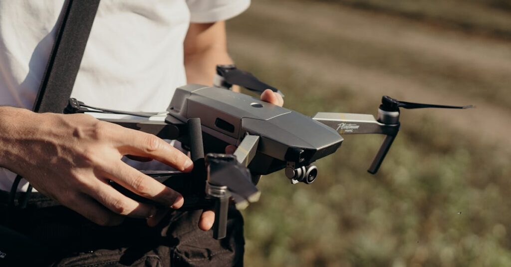 Close-up of a man holding a drone outdoors, showcasing drone technology preparation.