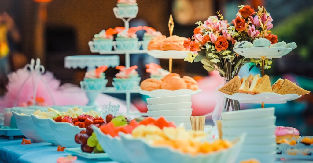 Colorful dessert table featuring a variety of fruits, cakes, and floral decor, ideal for celebrations.